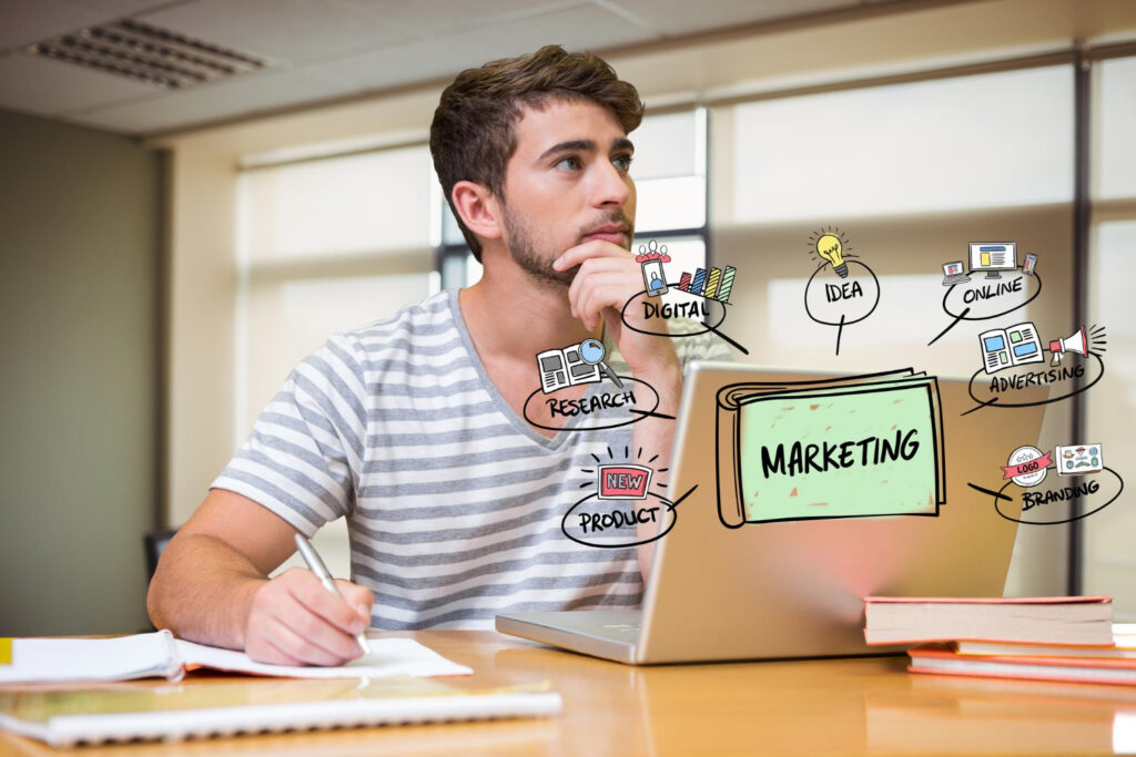 thoughtful businessman with laptop and marketing graphics in office